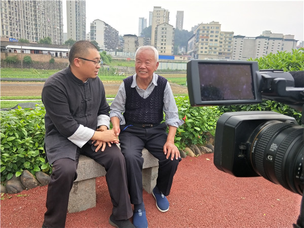 02、管其乾用自购的专业摄像机拍摄了廖延斌导师(左)访问洪田镇见过红军的93岁老人游启超(管其乾 摄).jpg